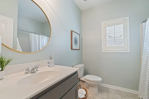 a bathroom with a sink toilet and mirror