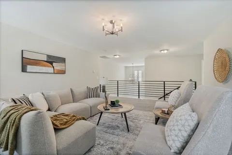 a living room with furniture a rug and a window