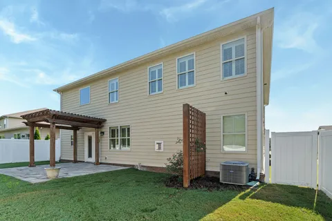 a backyard of a house with table and chairs