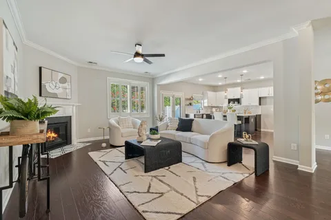 a living room with furniture fireplace and wooden floor