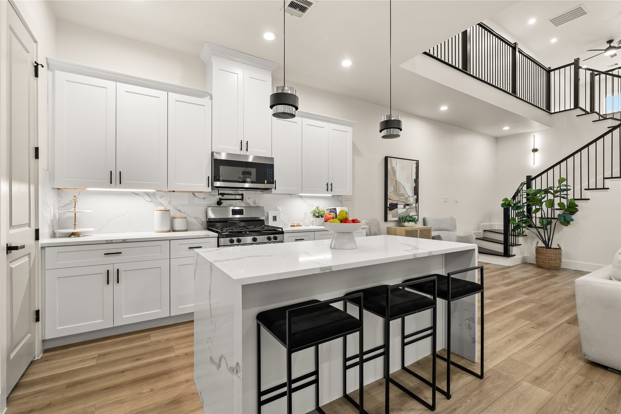 3539 Mainer Street, Unit B Houston, TX 77021 - Photo 7 of 29 Island view with bold pendant lighting and open sightlines into the living room