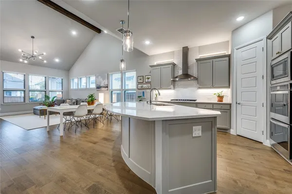 a kitchen with lots of counter top space and furniture