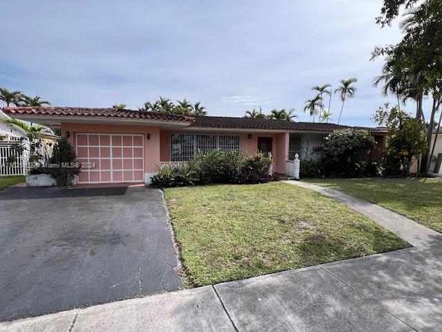 8253 West 14th Court Hialeah, FL 33014 - Photo 1 of 13 front view of a house with a yard