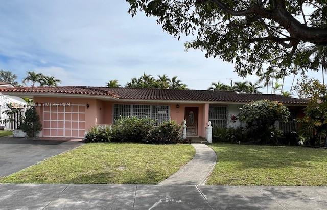 8253 West 14th Court Hialeah, FL 33014 - Photo 2 of 13 front view of a house with a yard