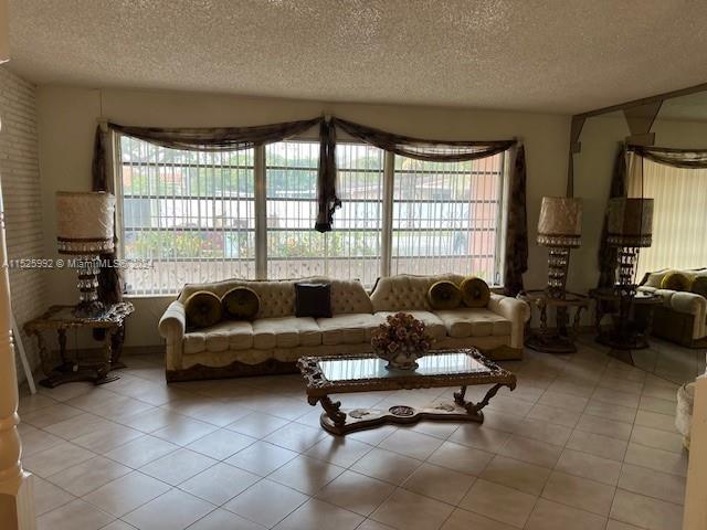 8253 West 14th Court Hialeah, FL 33014 - Photo 3 of 13 a living room with furniture and large windows