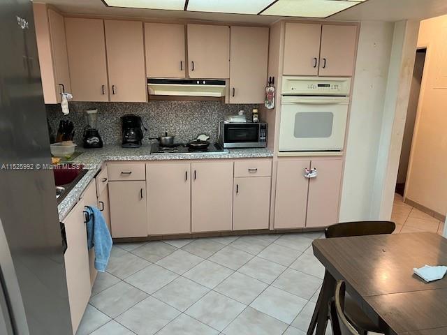 8253 West 14th Court Hialeah, FL 33014 - Photo 6 of 13 a kitchen with stainless steel appliances granite countertop a sink stove and cabinets