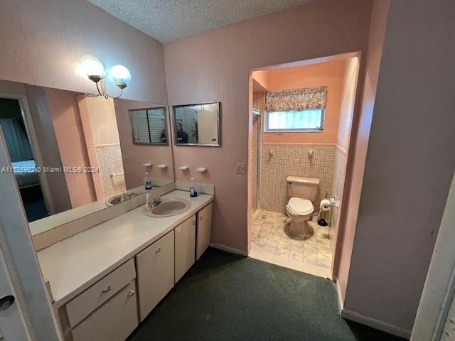 8253 West 14th Court Hialeah, FL 33014 - Photo 8 of 13 a bathroom with a sink a toilet and mirror