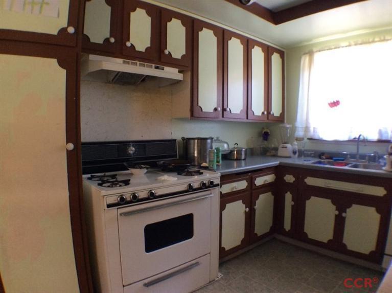 4213 Rigel Avenue Lompoc, CA 93436 - Photo 3 of 13 a kitchen with a stove and white cabinets