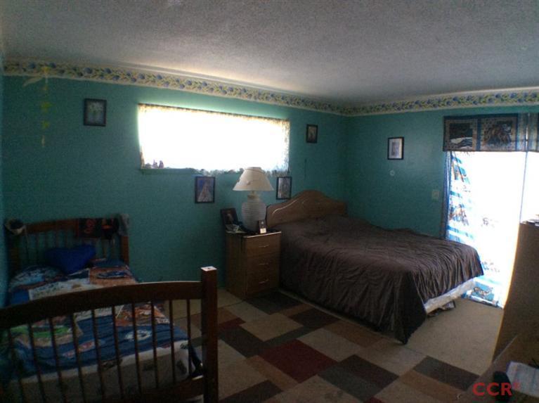 4213 Rigel Avenue Lompoc, CA 93436 - Photo 8 of 13 a bedroom with a bed and windows