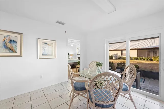 a living room with furniture a table and a large window