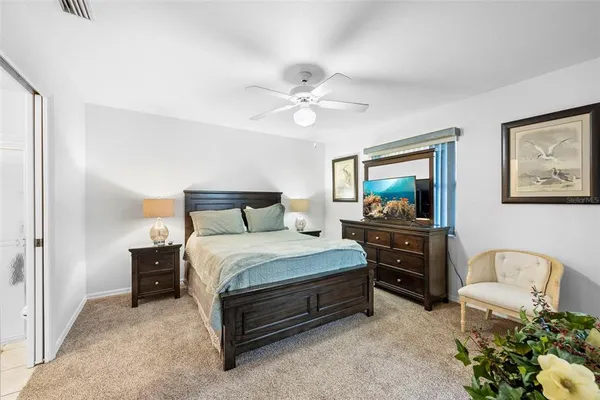 a bedroom with a bed dresser and a window