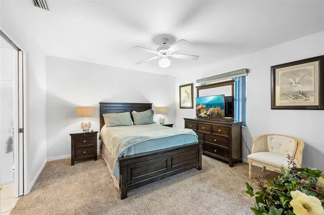 a bedroom with a bed dresser and a window