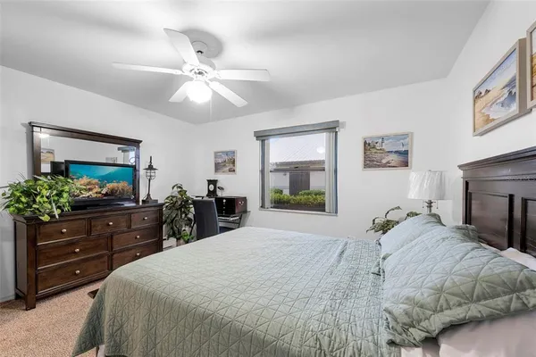 a bedroom with a bed and a dresser in it