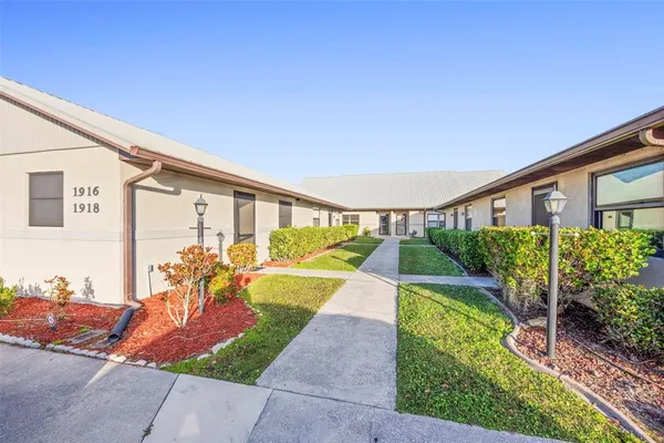 a view of a house with backyard porch and furniture