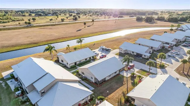 an aerial view of residential houses with outdoor space and ocean view