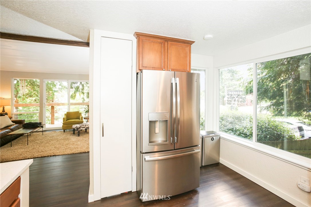 218 221st Street Southwest Bothell, WA 98021 - Photo 12 of 40 a kitchen with stainless steel appliances a refrigerator and wooden floor