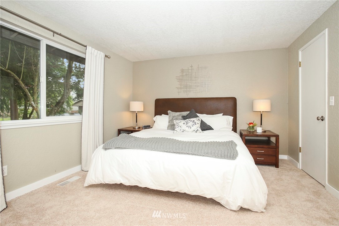218 221st Street Southwest Bothell, WA 98021 - Photo 13 of 40 a bedroom with a bed and large window