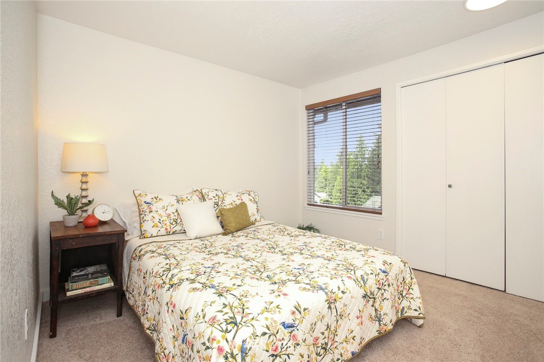 218 221st Street Southwest Bothell, WA 98021 - Photo 16 of 40 a bedroom with a bed and a window