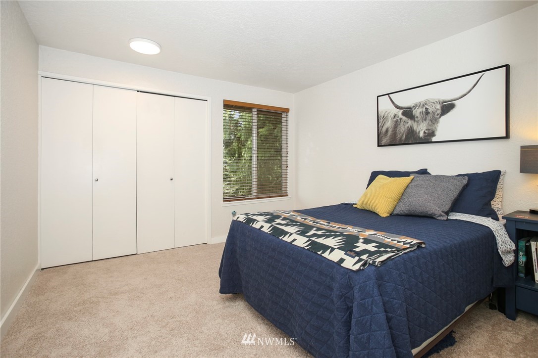 218 221st Street Southwest Bothell, WA 98021 - Photo 17 of 40 a bedroom with a bed and a painting on the wall