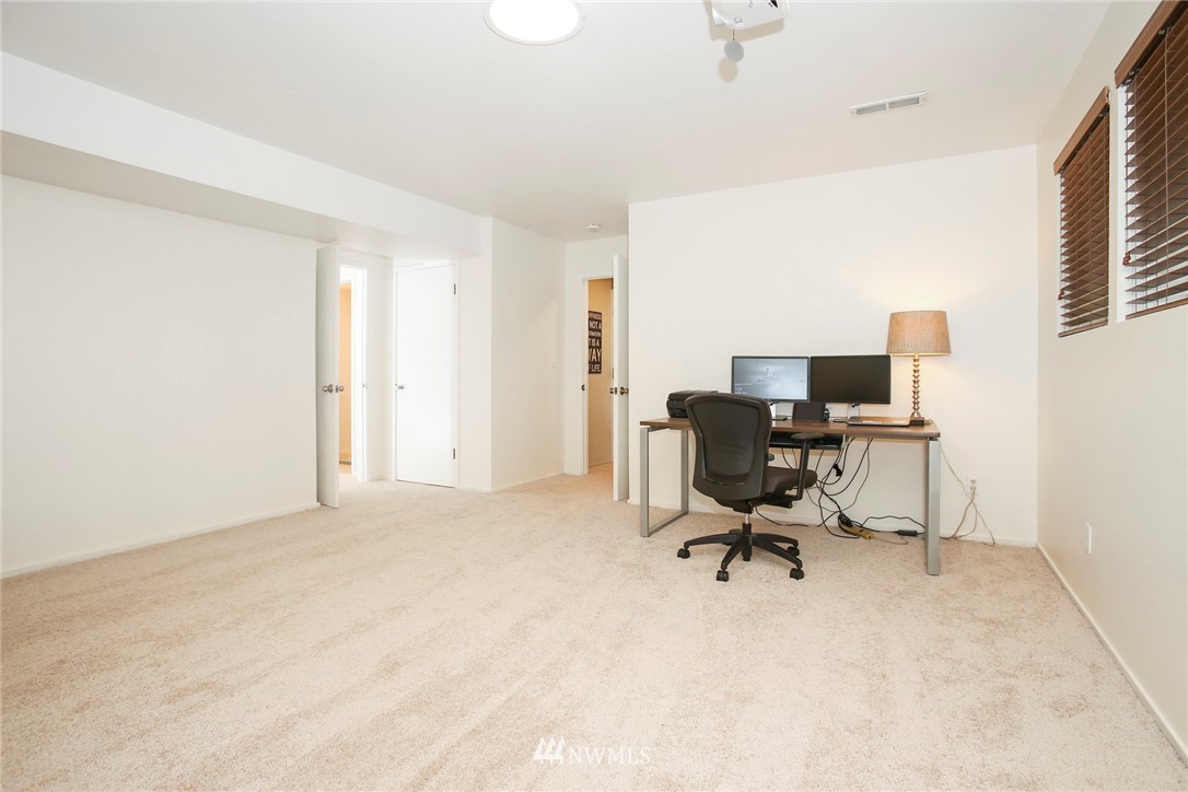 218 221st Street Southwest Bothell, WA 98021 - Photo 22 of 40 a view of a workspace with furniture and a window