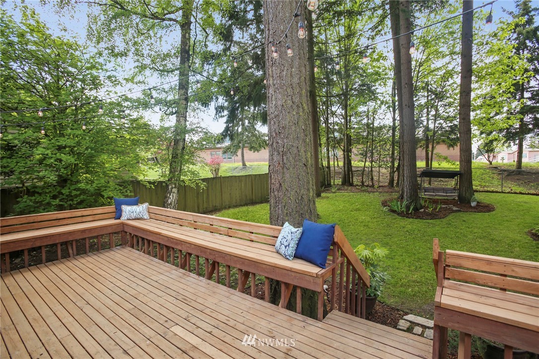 218 221st Street Southwest Bothell, WA 98021 - Photo 30 of 40 a view of a wooden deck with chairs and a yard