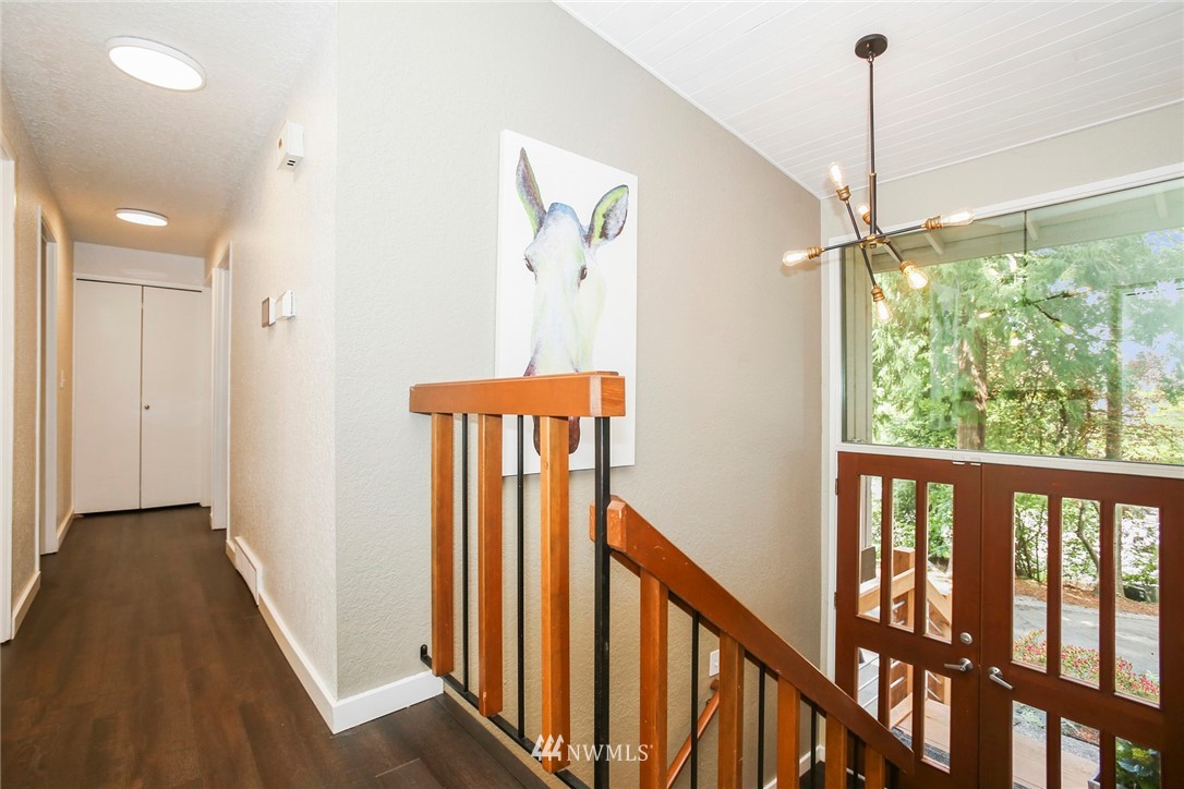218 221st Street Southwest Bothell, WA 98021 - Photo 4 of 40 a view of a hallway with windows and stairs