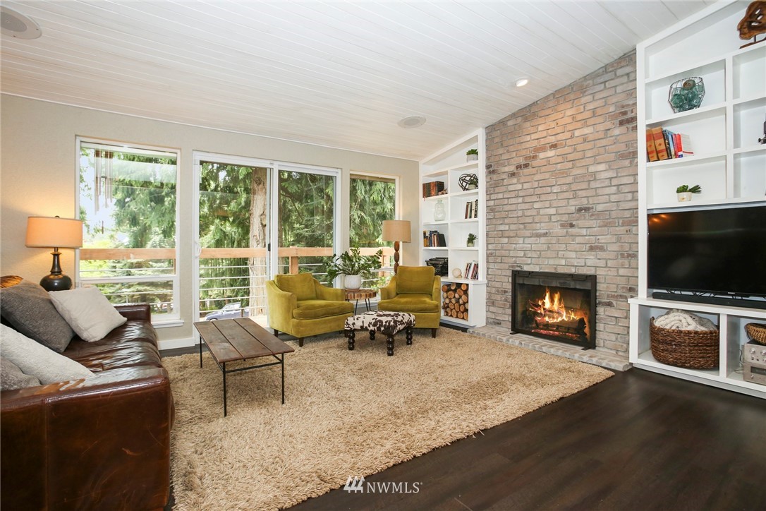 218 221st Street Southwest Bothell, WA 98021 - Photo 5 of 40 a living room with furniture a flat screen tv and a fireplace