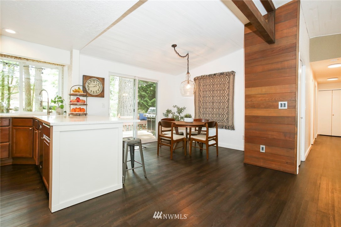 218 221st Street Southwest Bothell, WA 98021 - Photo 10 of 40 a view of dining room and kitchen with furniture window and wooden floor