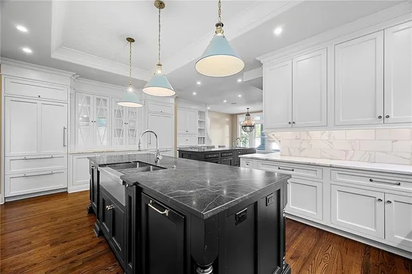 a kitchen with granite countertop a sink and a stove top oven