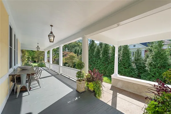 a view of balcony with furniture and garden