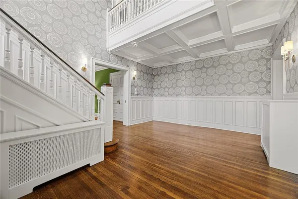 a view of an entryway with wooden floor