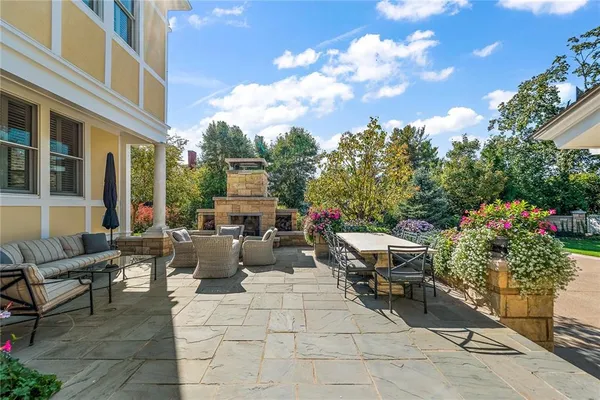 a view of a house with a big yard and potted plants