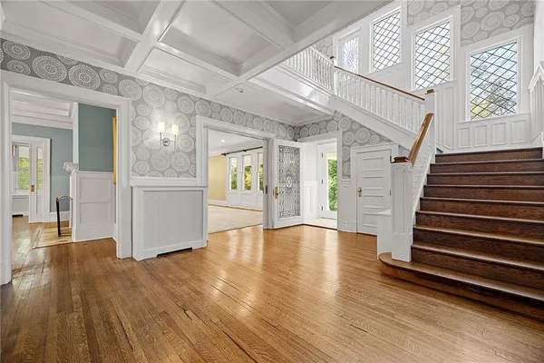 a view of an entryway with wooden floor and a window