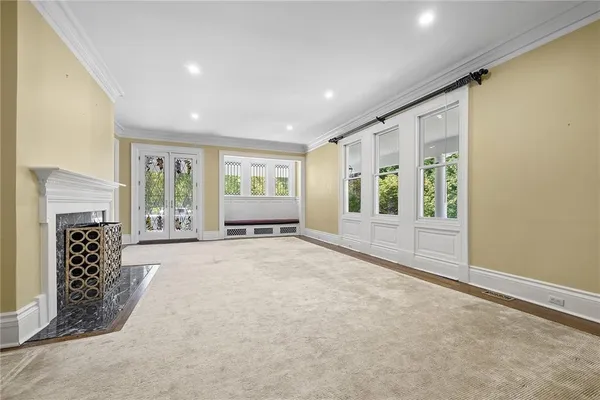 a view of an empty room with a fireplace