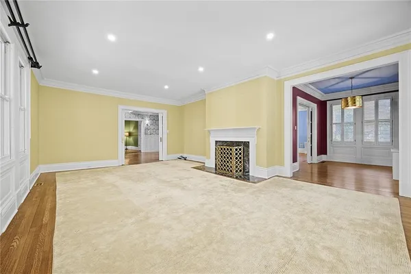 a view of an empty room with a fireplace and a window