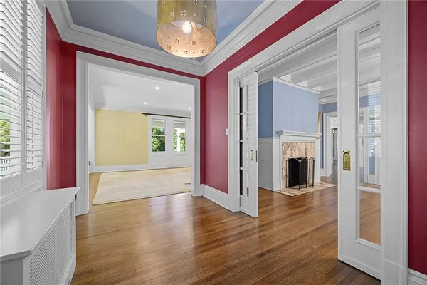 a view of a room with wooden floor and chandelier