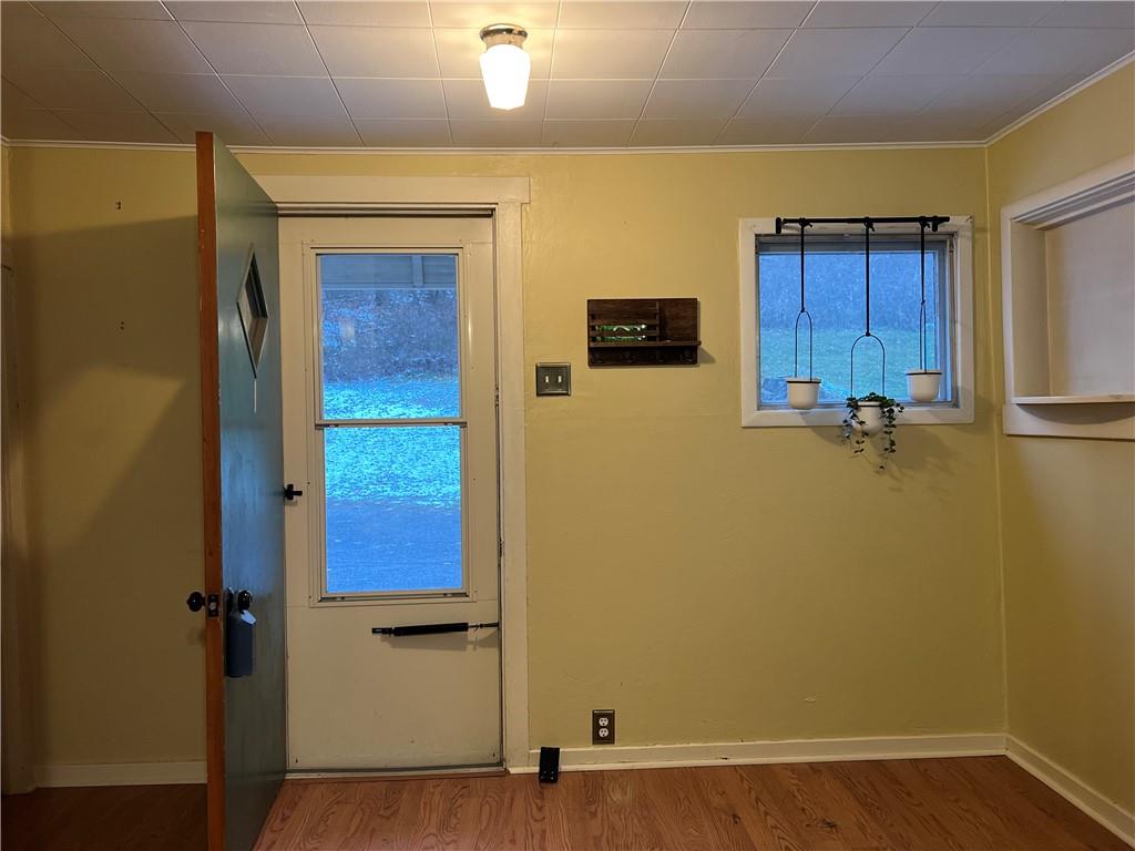 263 Whitestown Road Butler, PA 16001 - Photo 6 of 44 a view of an empty room with wooden floor and a window