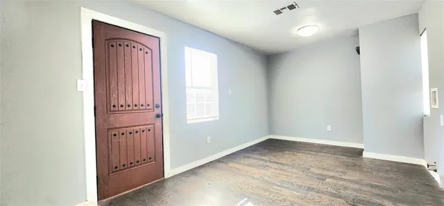 an empty room with windows and closet