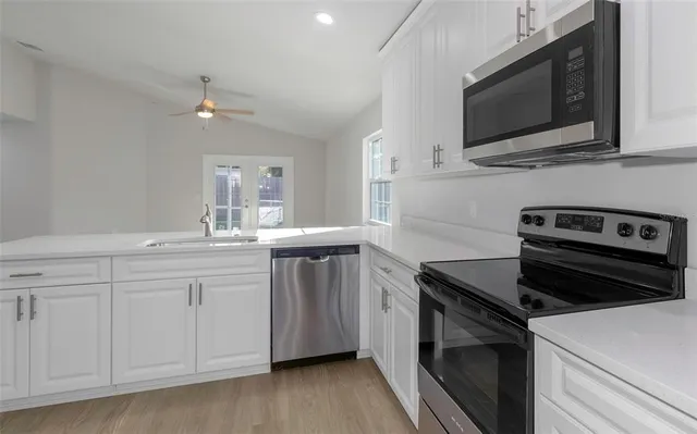 a kitchen with a sink stove and microwave