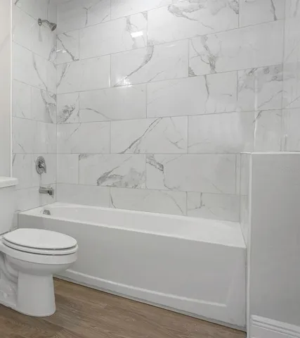 a bathroom with a bathtub and a toilet