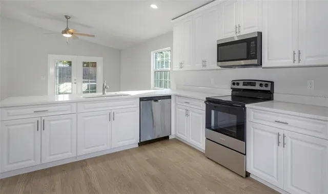 a kitchen with a sink stove and microwave