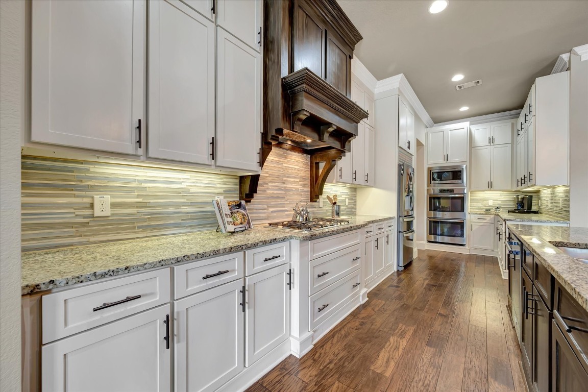 3108 Tyler Court Friendswood, TX 77546 - Photo 16 of 50 a kitchen with granite countertop white cabinets and white appliances