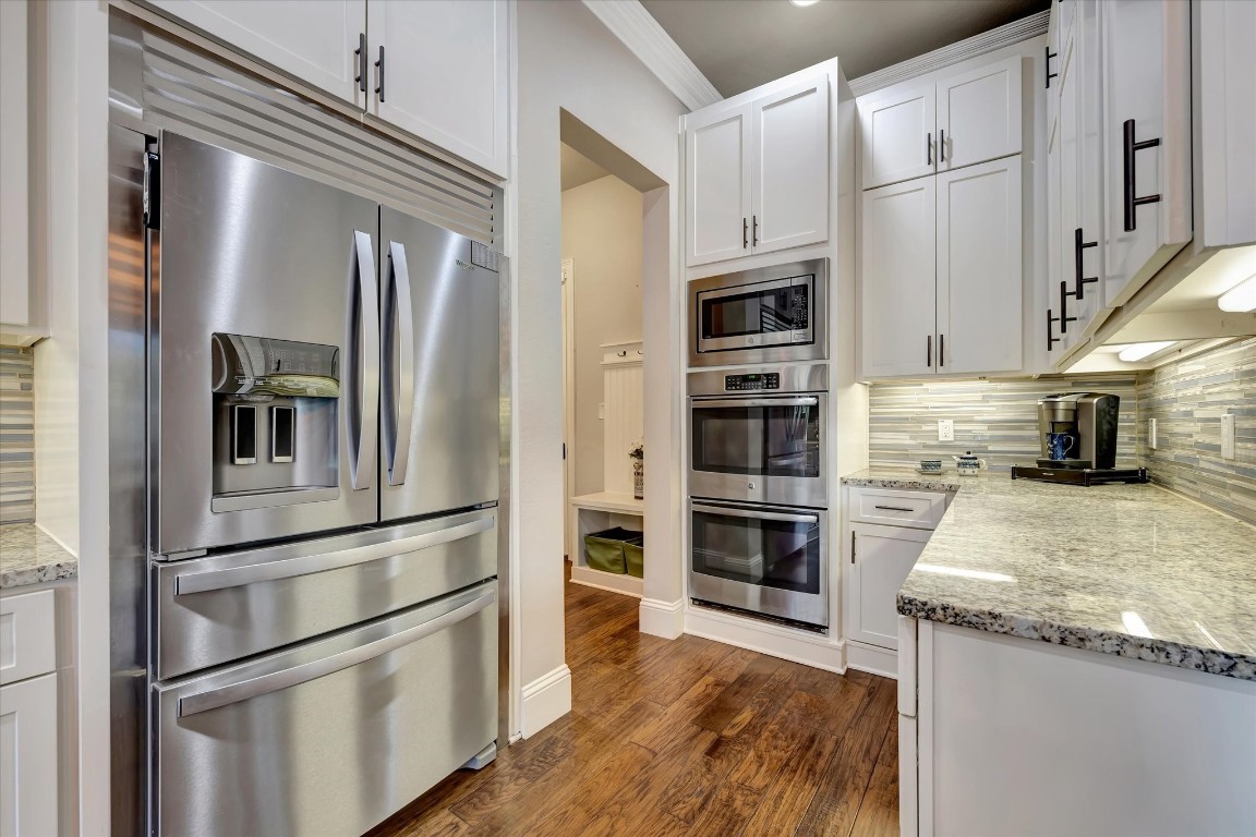 3108 Tyler Court Friendswood, TX 77546 - Photo 17 of 50 a kitchen with stainless steel appliances and refrigerator