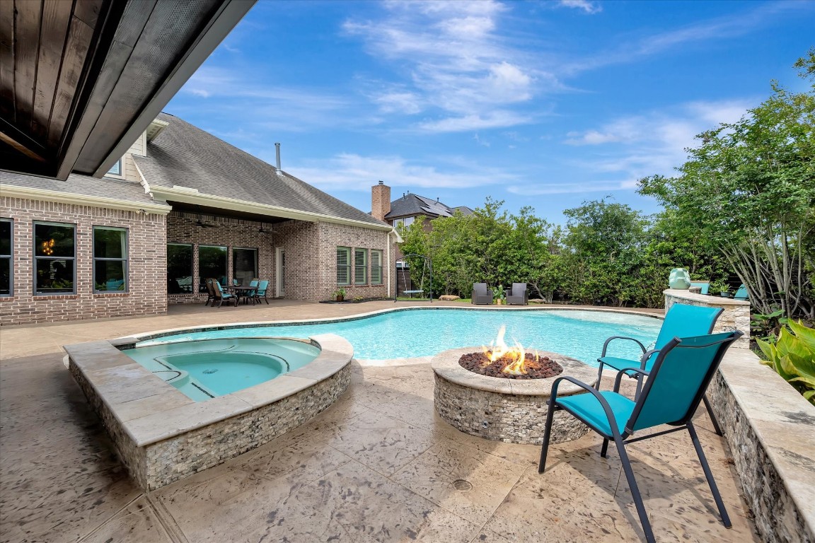 3108 Tyler Court Friendswood, TX 77546 - Photo 2 of 50 a view of a swimming pool with a patio