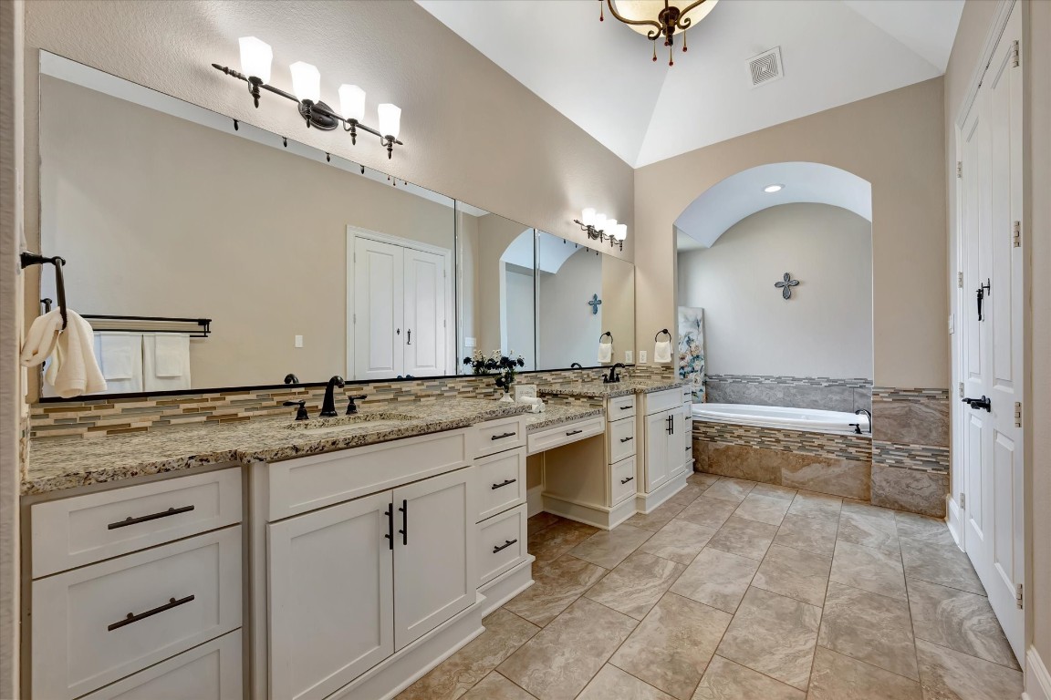 3108 Tyler Court Friendswood, TX 77546 - Photo 21 of 50 a bathroom with a granite countertop sink mirror and bathtub