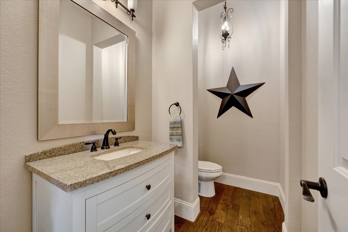 3108 Tyler Court Friendswood, TX 77546 - Photo 28 of 50 a bathroom with a granite countertop sink toilet and a mirror