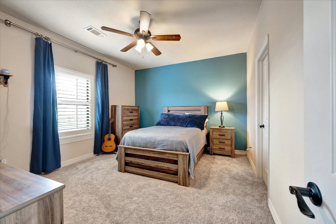 3108 Tyler Court Friendswood, TX 77546 - Photo 35 of 50 a bedroom with a bed and a chandelier