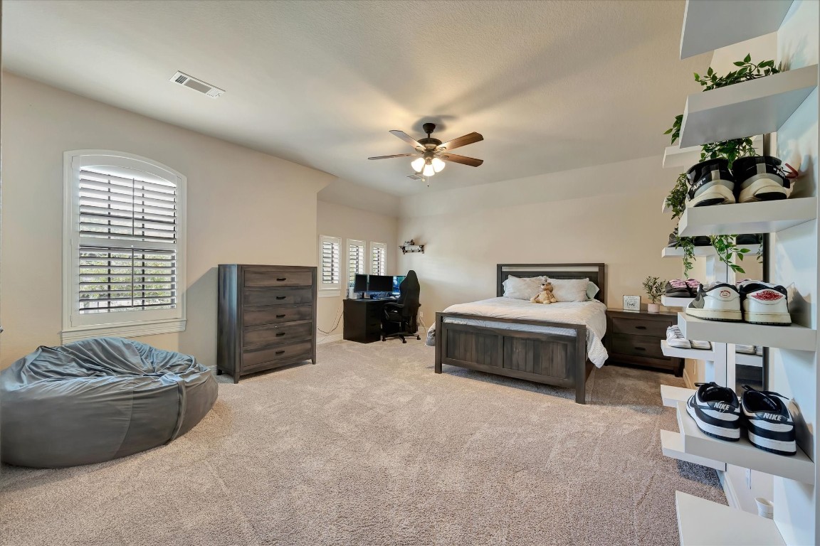 3108 Tyler Court Friendswood, TX 77546 - Photo 37 of 50 a spacious bedroom with a bed and a couch