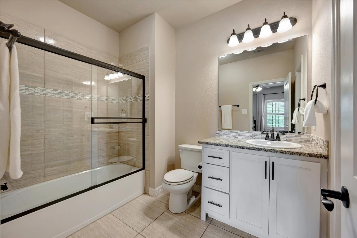 3108 Tyler Court Friendswood, TX 77546 - Photo 40 of 50 a bathroom with a granite countertop sink toilet and shower