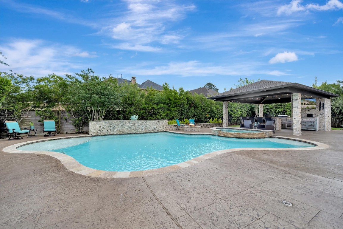 3108 Tyler Court Friendswood, TX 77546 - Photo 42 of 50 a swimming pool with outdoor seating and yard
